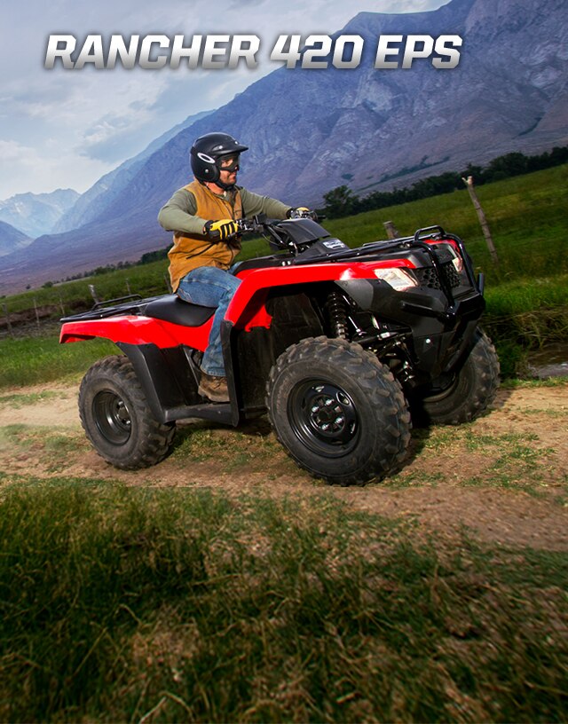 TRX420 Rancher EPS. Power with ease. Image of determined ATV rider driving along green field backed by enormous mountains.