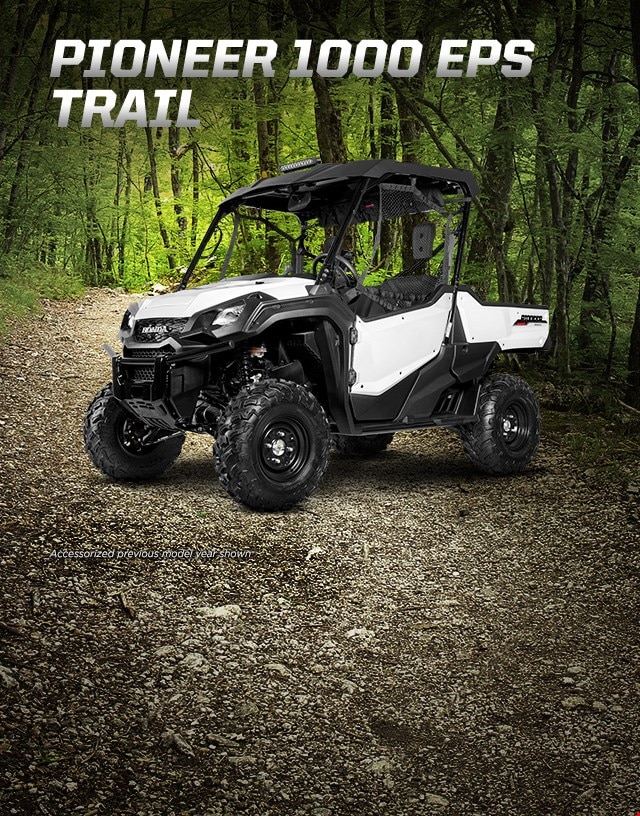Pioneer 1000 EPS Trail. Go beyond extraordinary. White side-by-side with hard roof and mounted LED light bar ready to explore deep forested trail