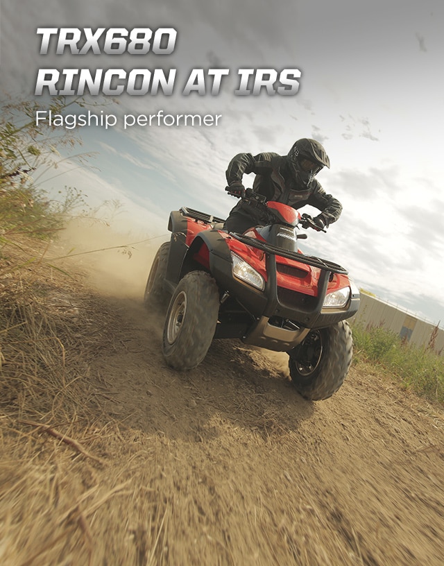 TRX680 Rincon AT IRS. Flagship performer. Image of ATV rider excitedly speeding down a rough dirt trail along rural countryside on red ATV