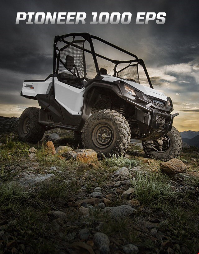 Pioneer 1000 EPS. Go beyond extraordinary. Image of a striking red side-by-side parked on wild off-road terrain among blue skies and snow capped mountain peaks
