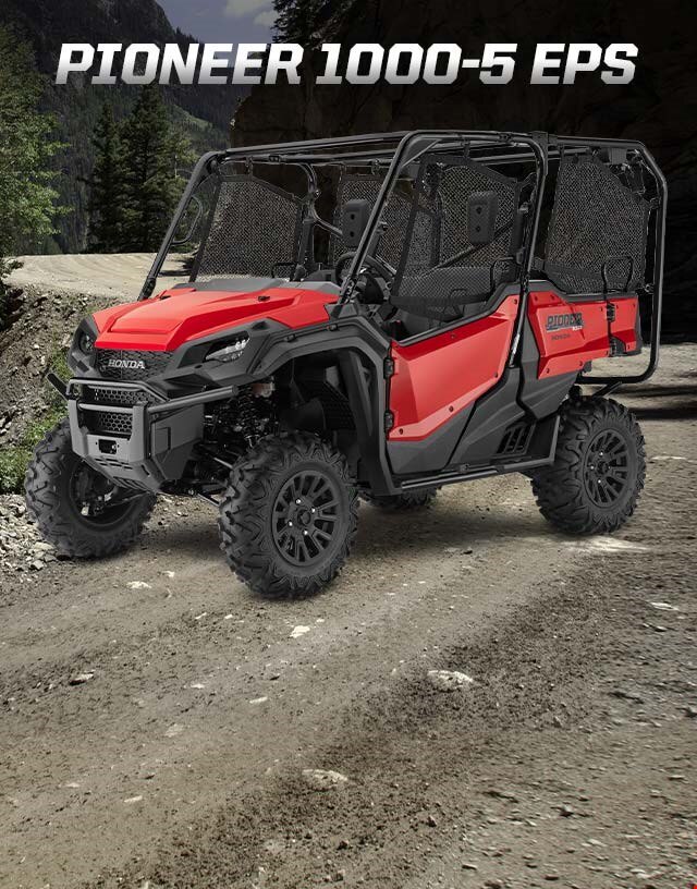 Pioneer 1000-5 EPS. Go beyond extraordinary. Image of a striking red side-by-side parked on wild off-road terrain among blue skies and snow capped mountain peaks