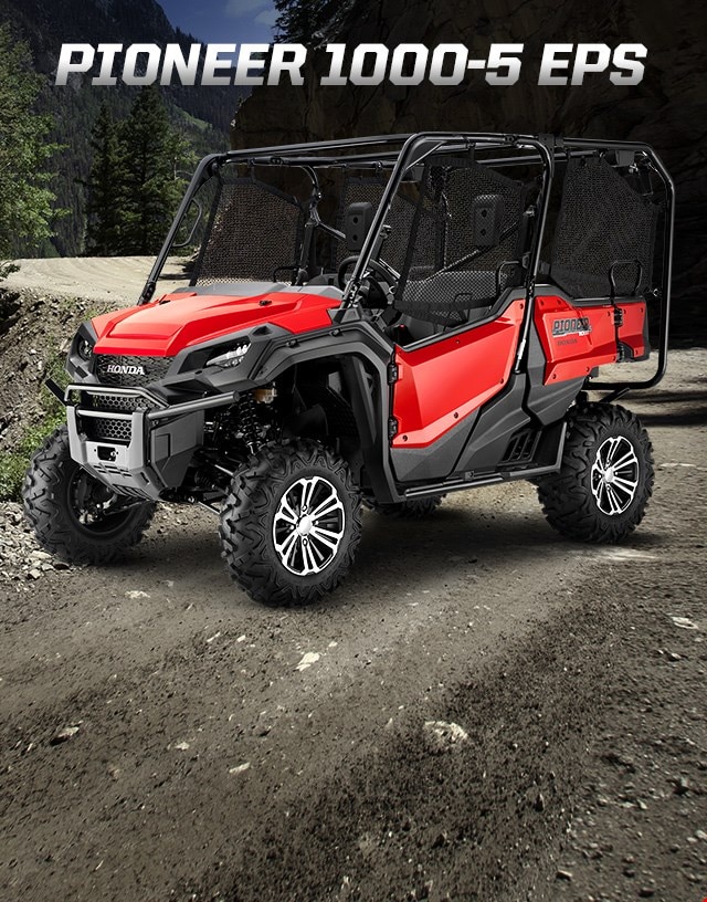Pioneer 1000-5 EPS. Go beyond extraordinary. Image of a striking red side-by-side parked on wild off-road terrain among blue skies and snow capped mountain peaks