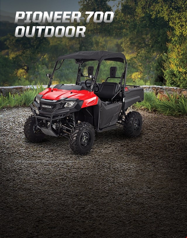 Pioneer 700-4 outdoor. Experienced expert. Image of ATV in garden.