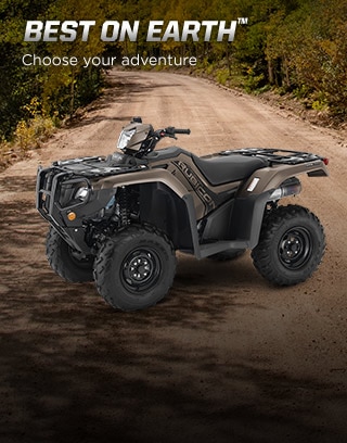 Best on Earth. Choose your adventure. Image of ATV rider in black helmet in standing position climbing over big boulders 