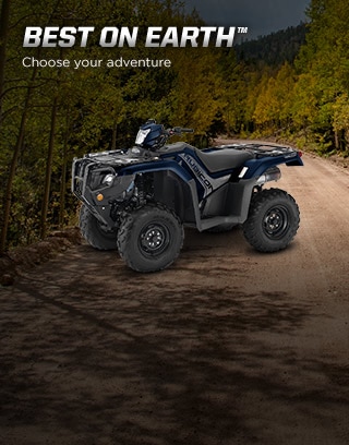 Best on Earth. Choose your adventure. Image of ATV rider in black helmet in standing position climbing over big boulders 