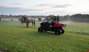 Side view of Pioneer 520 in front of horses