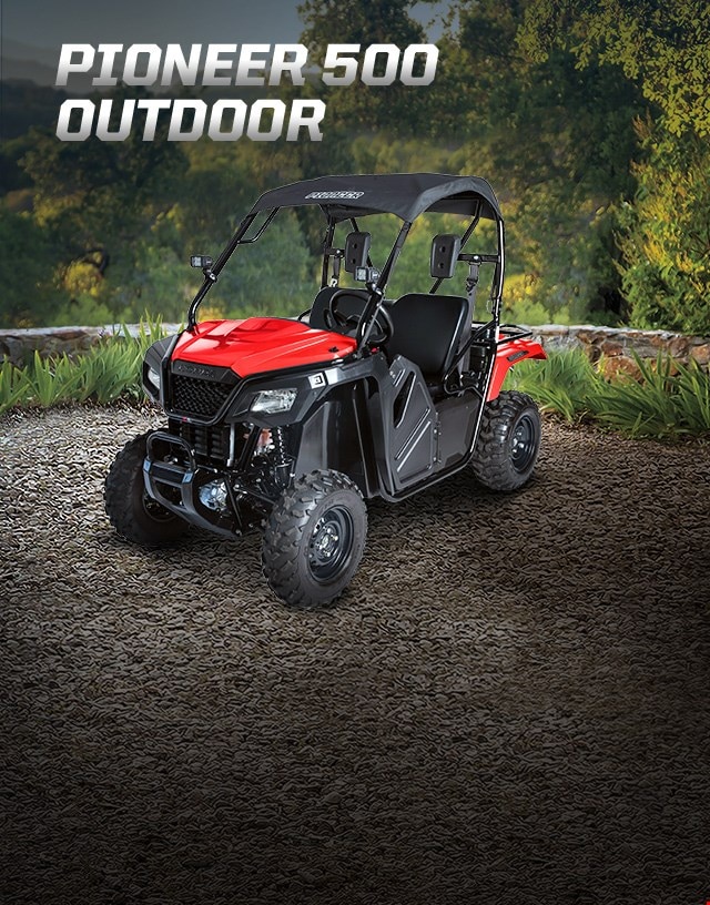 Pioneer 500 Outdoor. Adventures anywhere. Side-by-side parked on large gravel patio overlooking lush green woodland
