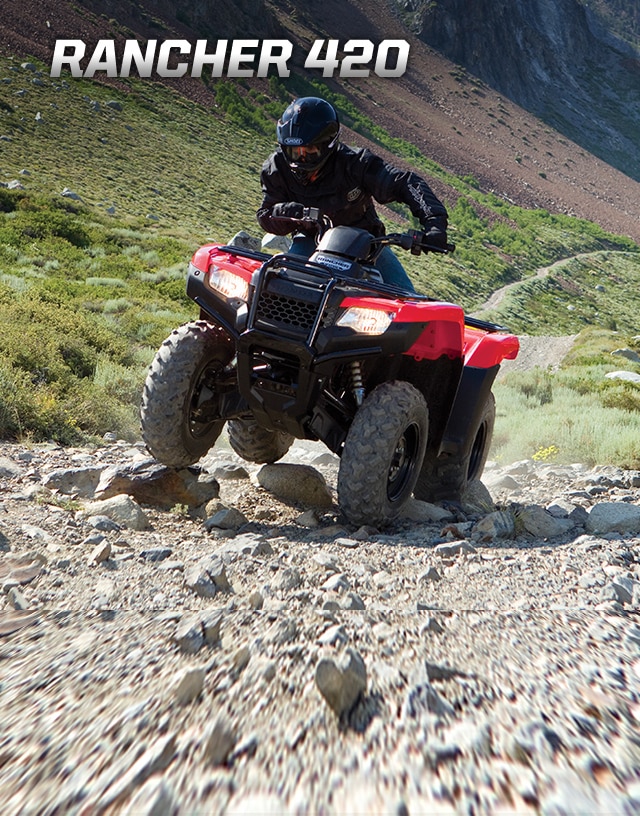 TRX420 Rancher. Modest size, bold personality. Image of rider on ATV manouevering over large rocks on a rugged trail incline.