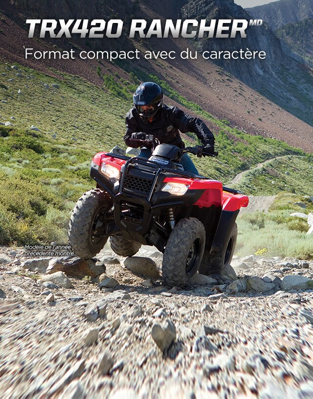 TRX420 Rancher. Taille modeste, personnalité flamboyante. Image d'un pilote de VTT qui manœuvre sur de gros rochers sur une piste accidentée en pente.