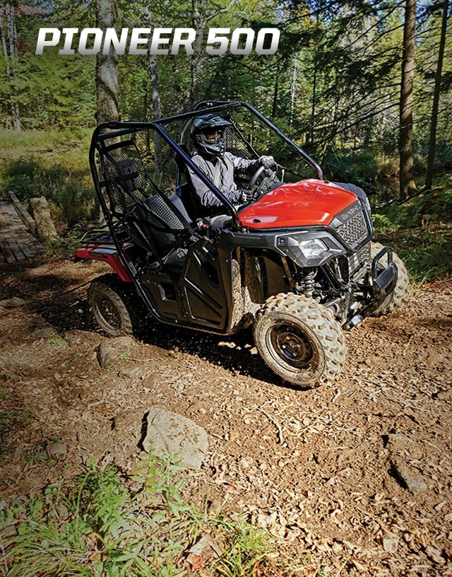 Pioneer 500. Adventures anywhere. Image of compact side-by-side speeding through rocky, muddy creek in the forest