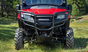 The red Pioneer 700-4 with strong steel front bumper and mounted side mirrors and auxilary lights