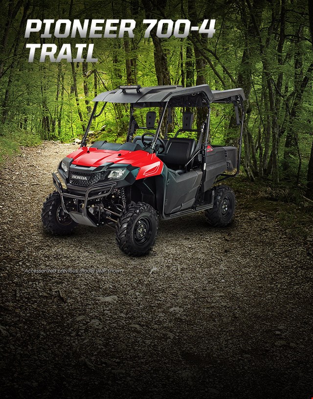Pioneer 700-4 Trail. Haul more, go further. Image of Pioneer vehicle in the forest.