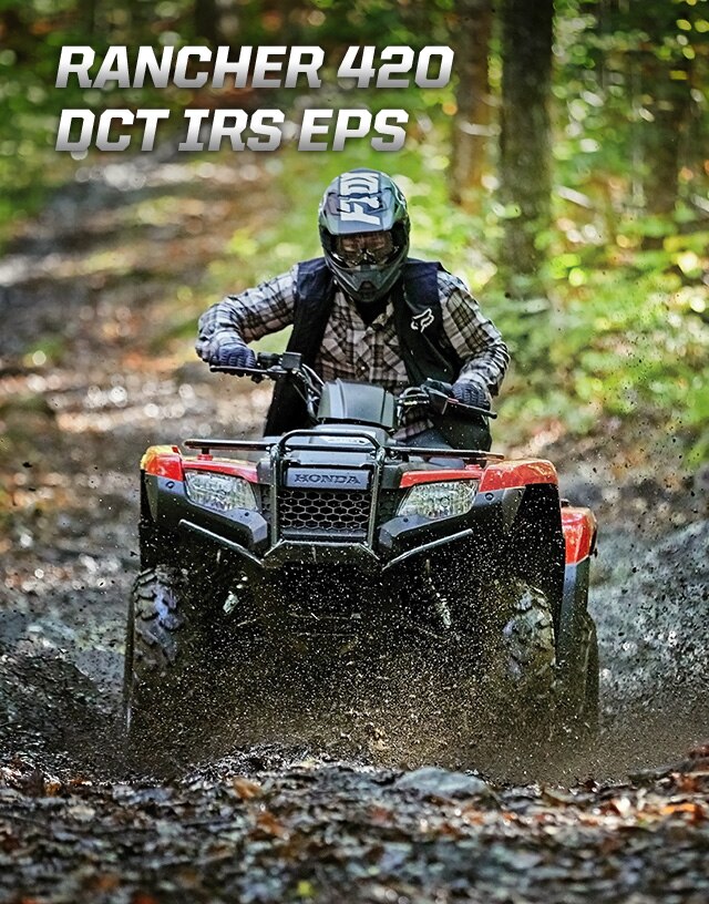 TRX420 Rancher DCT IRS EPS. Master of work and play. Image of white ATV parked in lush green forest.