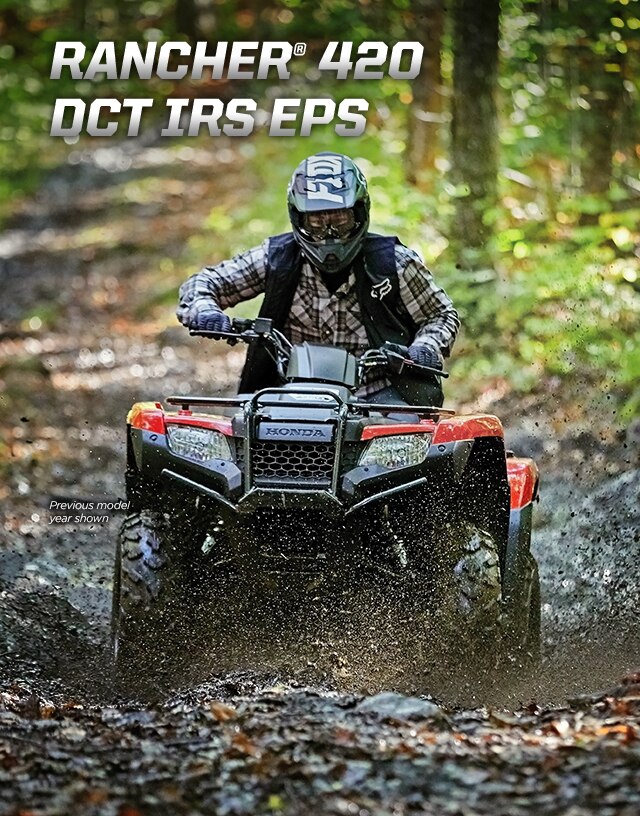 TRX420 Rancher DCT IRS EPS. Master of work and play. Image of white ATV parked in lush green forest.