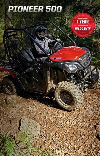 Pioneer 500. Adventures anywhere. Image of compact side-by-side speeding through rocky, muddy creek in the forest