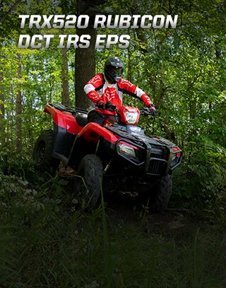 TRX500 Rubicon DCT IRS EPS. Ready for the challenge. Image of ATV rider powerfully steering up rugged dirt trail in the forest